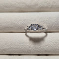 Silver ring with a diamond on a textured beige surface